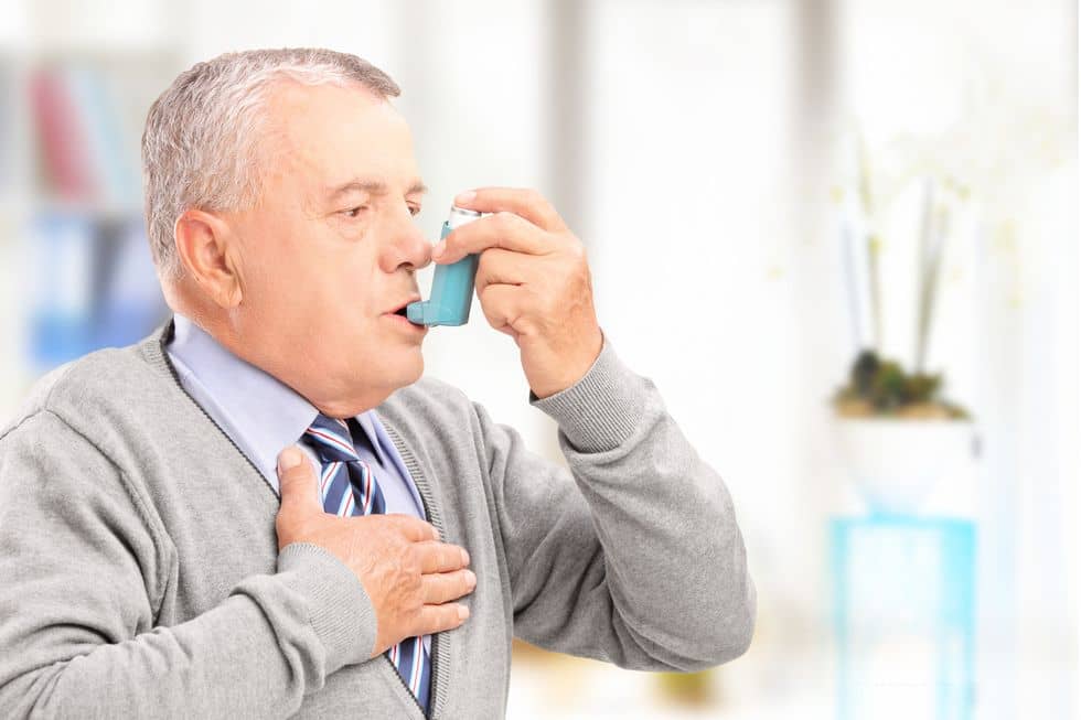 Man using an inhaler 